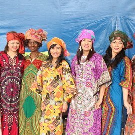 women on stage in colourful dresses