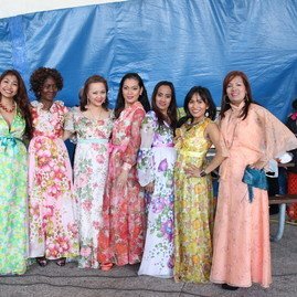 women on stage in colourful dresses